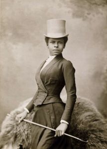 A woman and her riding habit, 1880s. 