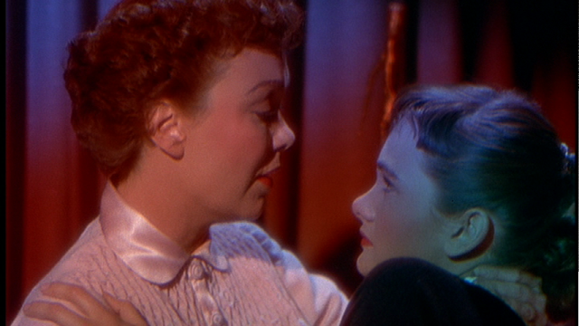 Cary (Jane Wyman) tries to relate her daughter. The reds and the blues indicate the tone of the scene. 